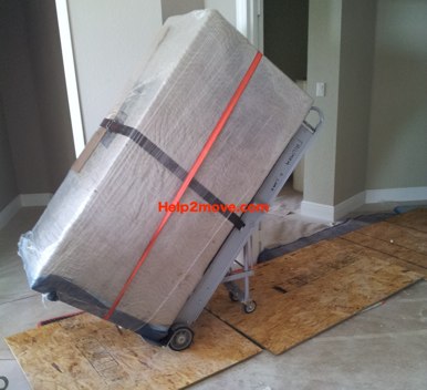 Gun Safe Mover: protection of gun safe with cardboard and shrink wrap